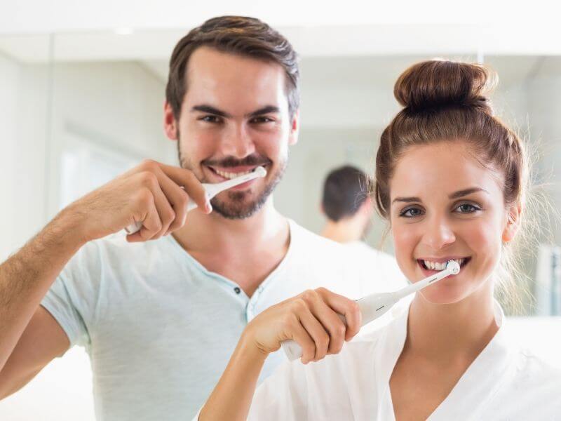 Young Couple Brushing Teeth
